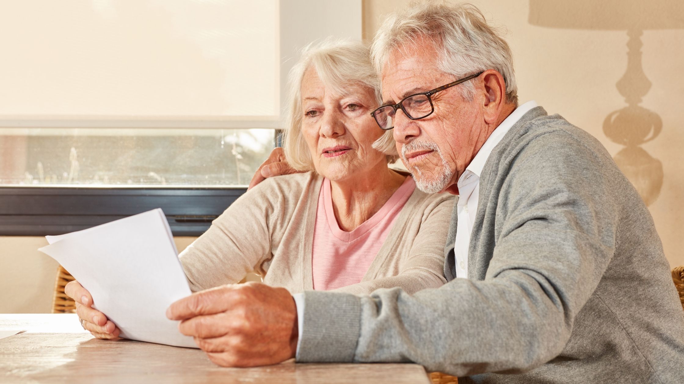 Retired couple reviewing their retirement income plan together at home