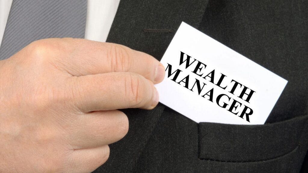 Wealth manager placing a business card in a suit jacket pocket